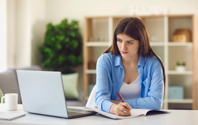  Focused young woman conducting niche selection strategy for dropshipping on her laptop at home